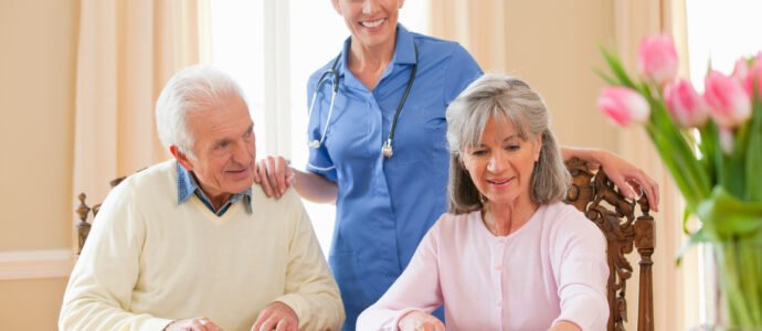 Caregiver providing core home support and companionship to a senior couple, assisting with daily living needs.